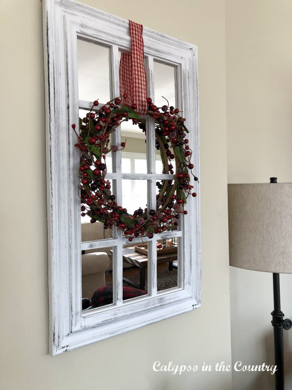 red wreath on mirror - Christmas decorating inspiration