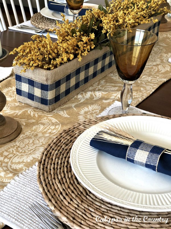 Gold and Blue table setting with buffalo check centerpiece