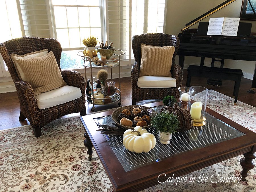 Coffee table, chairs and bar cart decorated for Thanksgiving