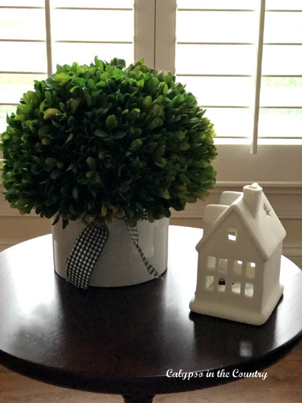 White ceramic house and greenery - Thanksgiving and Christmas decorating ideas