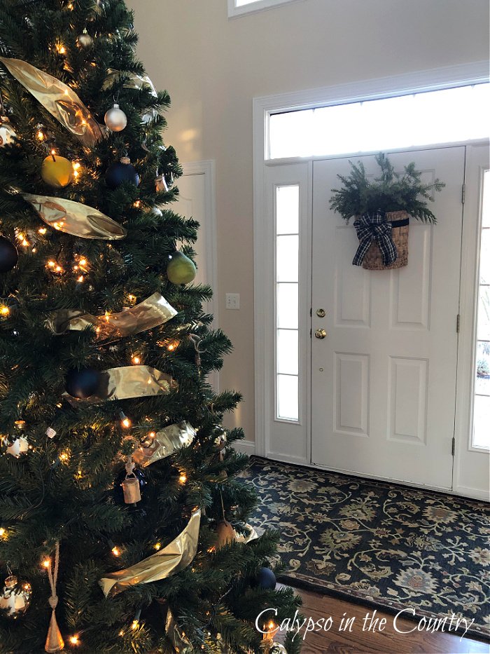 Christmas tree and door basket in foyer