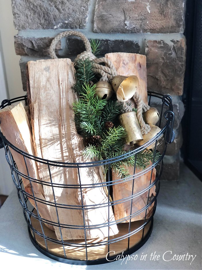 firewood and bells in wire basket - classic and cozy Christmas house tour