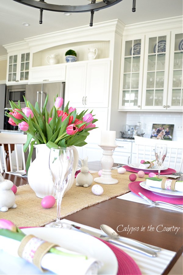 White kitchen and table set with pink flowers - most popular blog posts of 2021