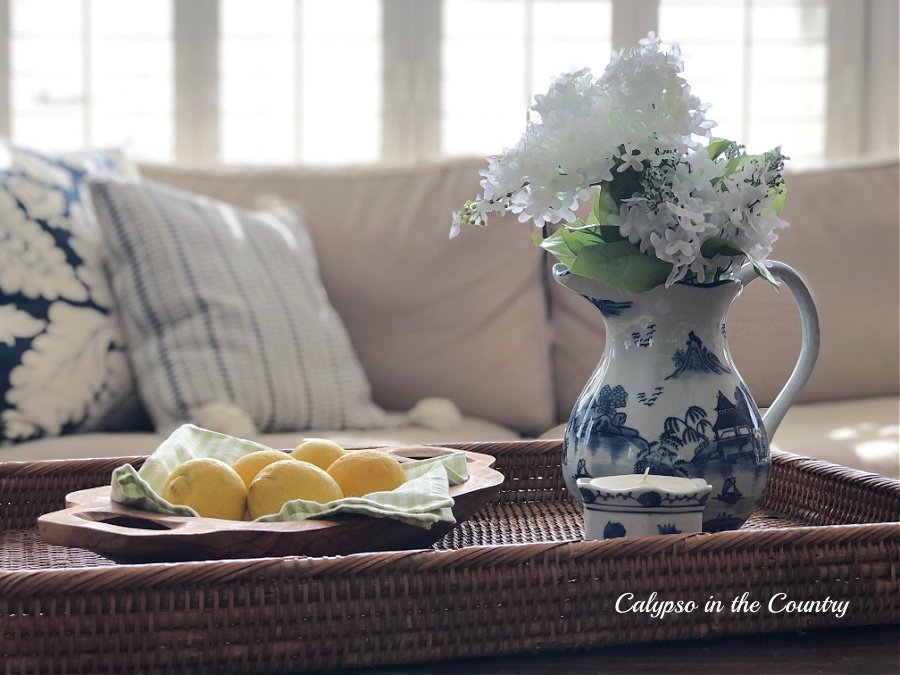 lemons and blue and white pitcher on rattan tray - spring decorating ideas
