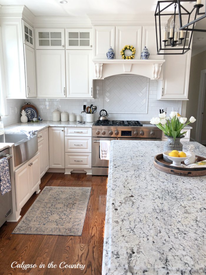 White kitchen decorated for spring with blue and yellow