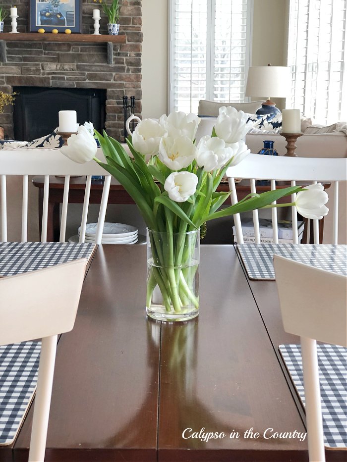 Vase of white tulips on table