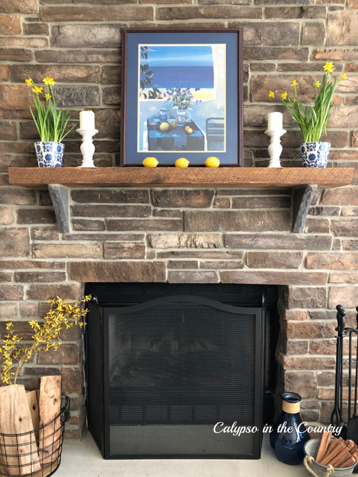 Stone fireplace with blue and yellow accessories - spring home decorating ideas