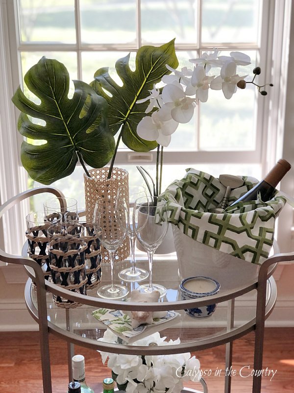 Bar cart with artificial greenery and orchid plant
