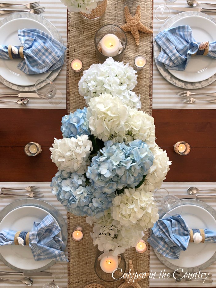 Overhead view of blue and white coastal table setting