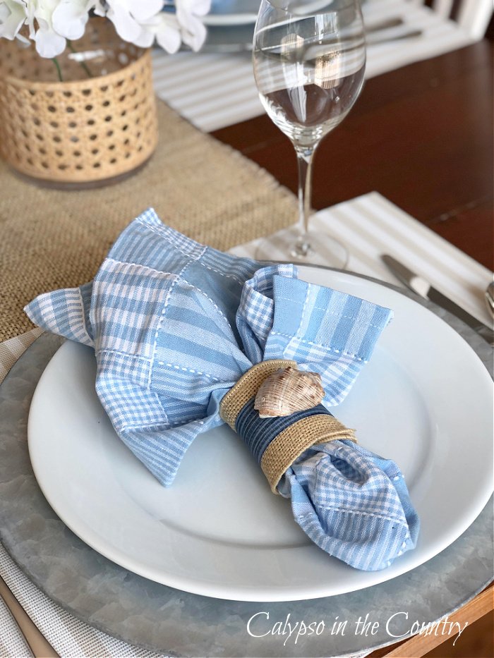 place setting with blue napkin and white plate