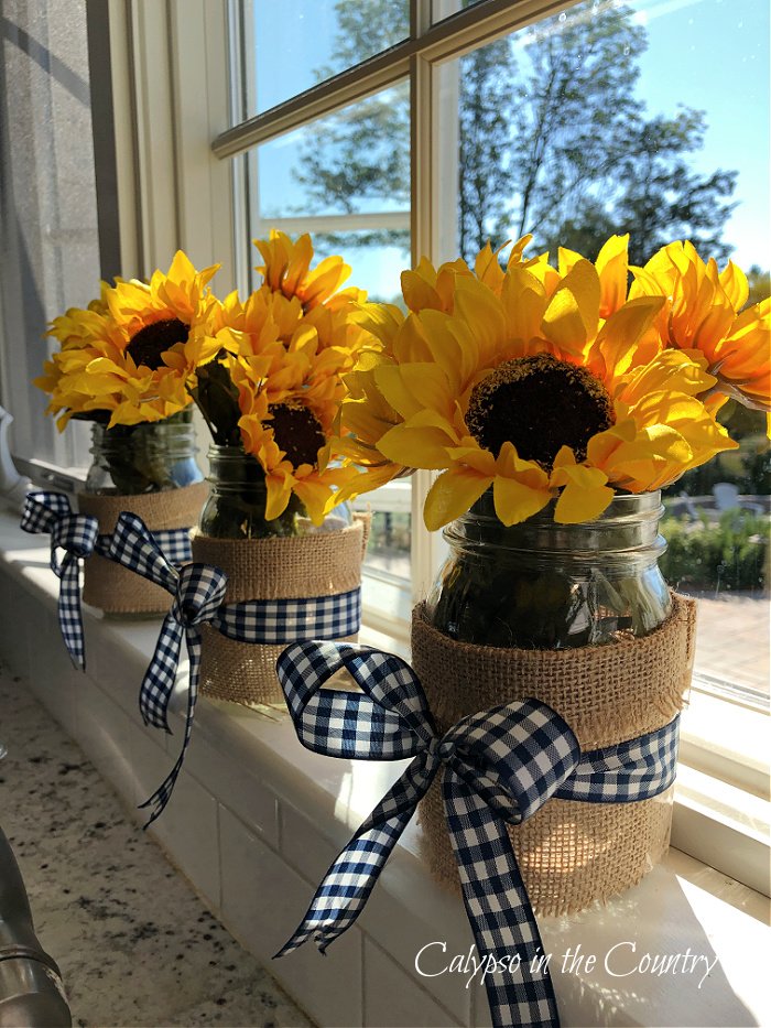 sunflowers in mason jars on window sill