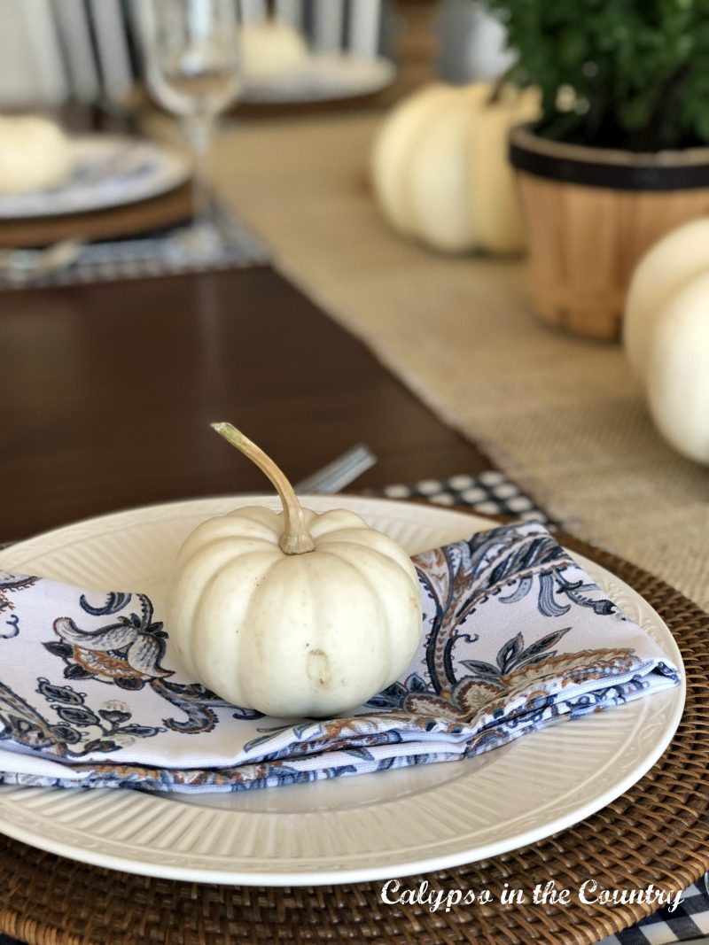 White pumpkin on place setting for fall