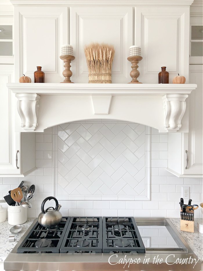 white stove mantel decorated with neutrals for fall