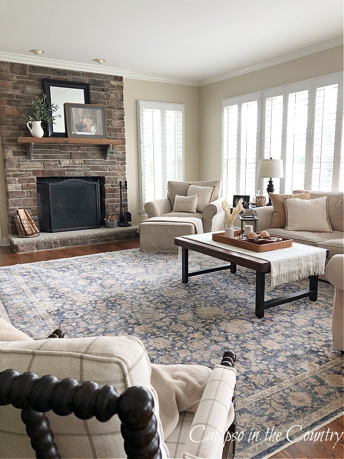 fall living room with stone fireplace - neutral fall decor ideas