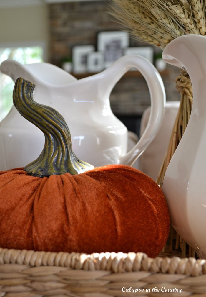 orange velvet pumpkin on tray with white pitchers - october decorating ideas