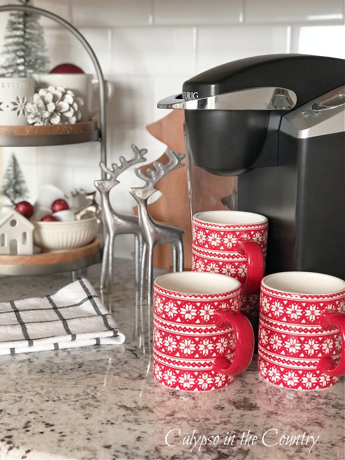 Red fair isle mugs with tiered tray and coffee machine