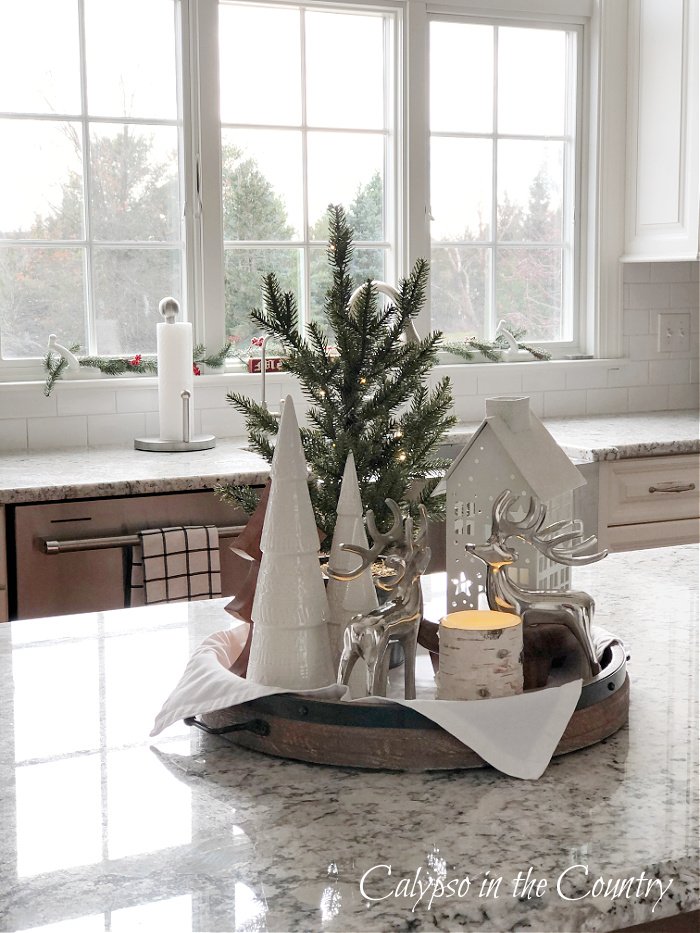 Kitchen island tray decor with round wooden tray and white Christmas decorations