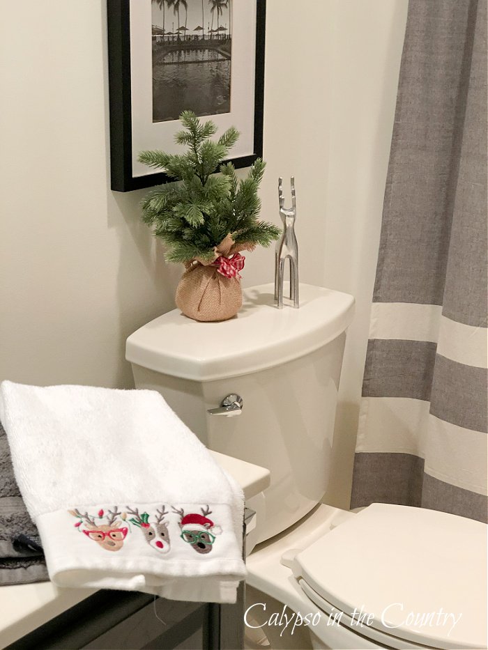 Christmas towel and decorations in boys gray bathroom