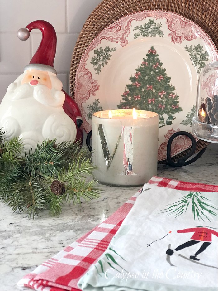 Kitchen counter decorated for Christmas with candle, Santa and Christmas tree plate