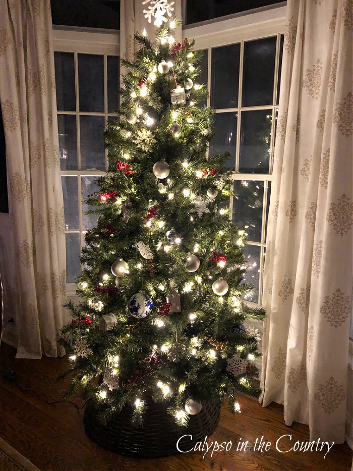 Christmas tree with white lights in bay window