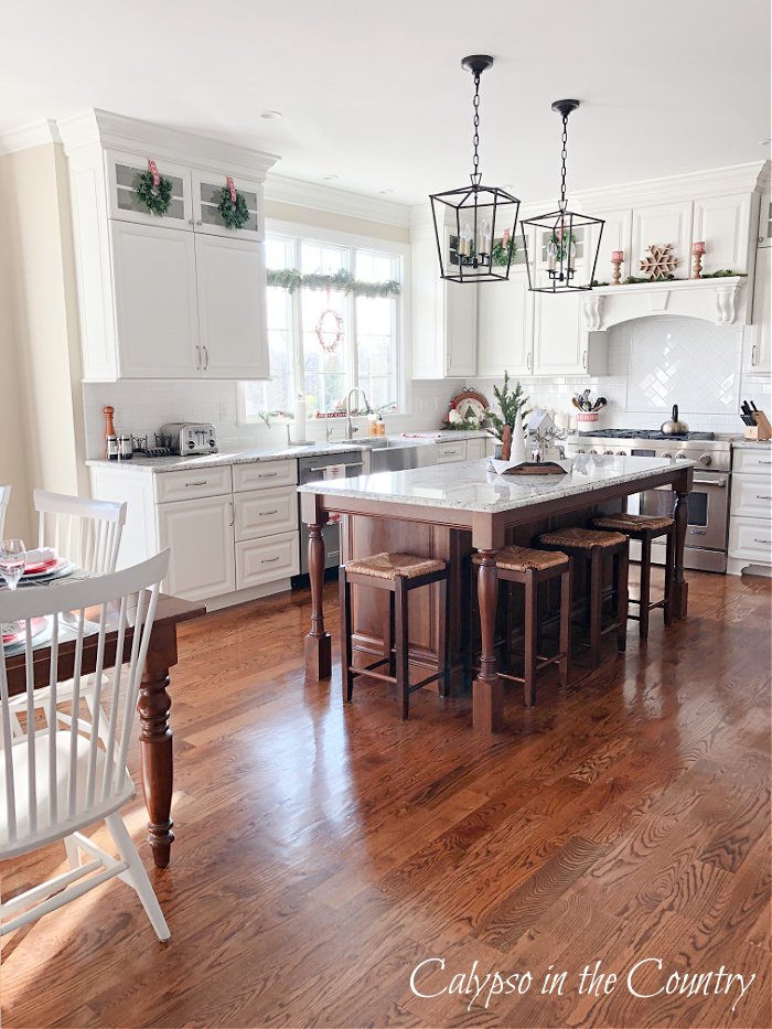 White kitchen with wood floors and stained wood island - 2022 christmas home tour