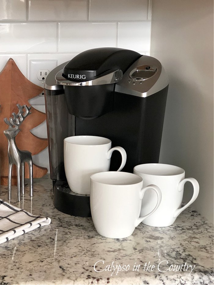 Black Keurig machine with white coffee cups - kitchen countertop coffee station ideas