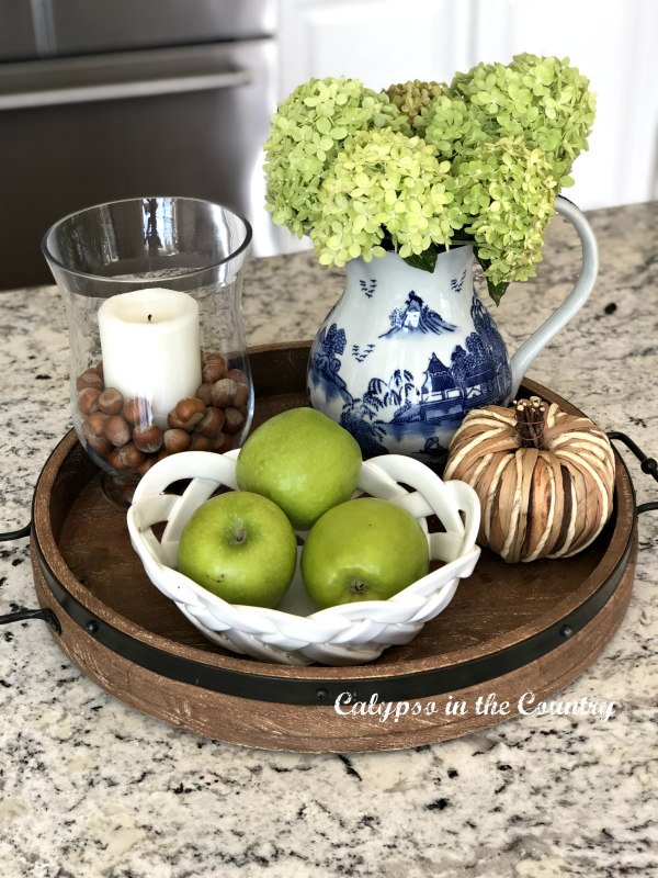 Round wooden tray with green apples and hydrangeas - most popular post of 2022