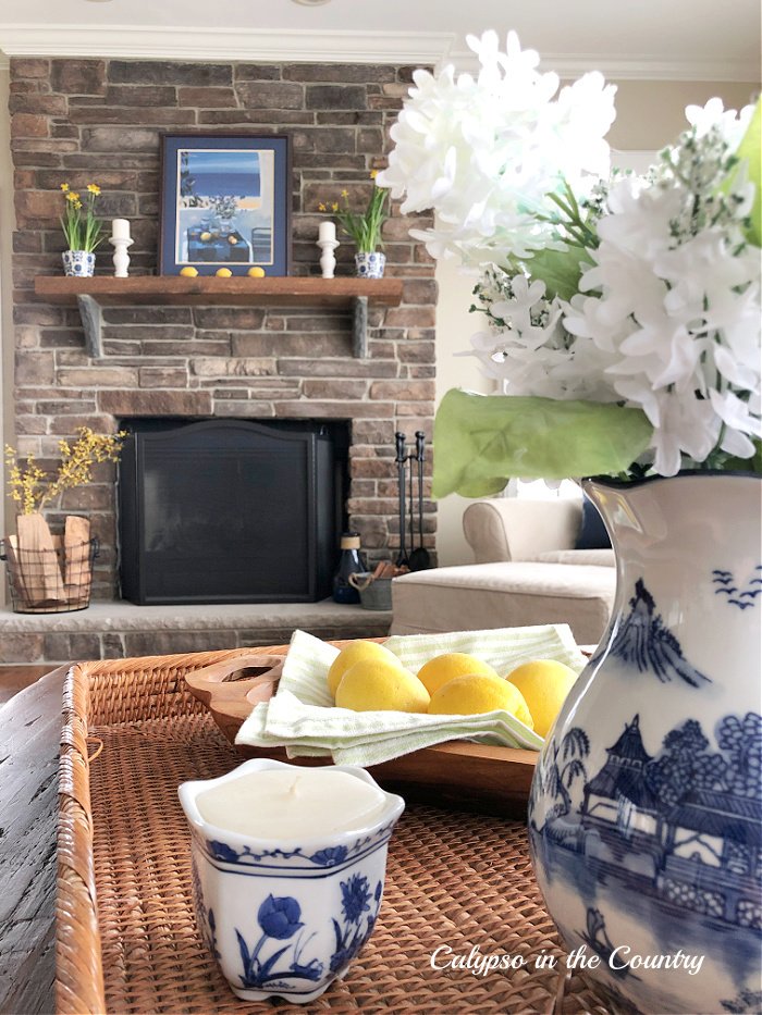 Blue and yellow accessories in family room and spring fireplace decor 