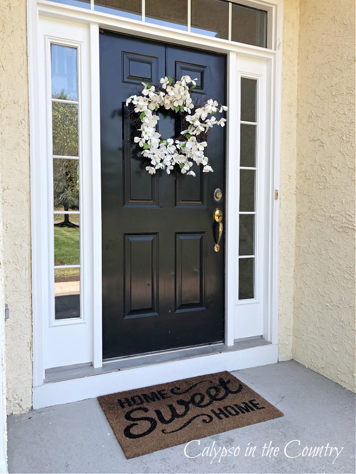 Dogwood wreath on black front door - spring door decor