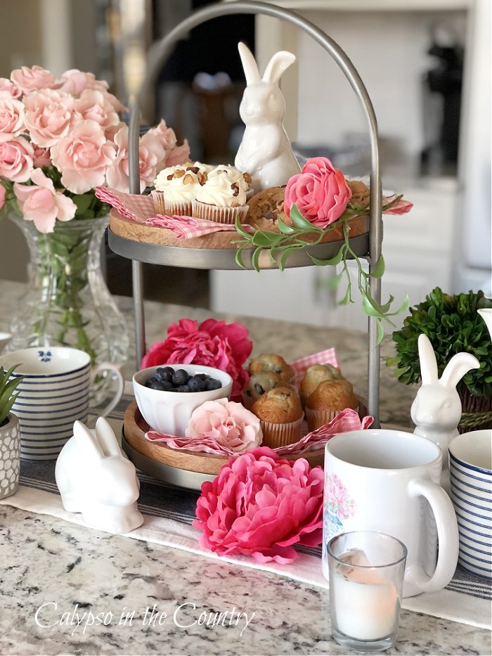 Pink flowers and tea party food on two tiered tray - how to decorate a tiered tray for tea time