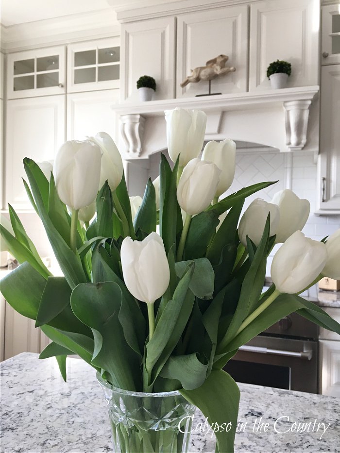 White tulips and white cabinets - kitchen island decorating ideas for spring