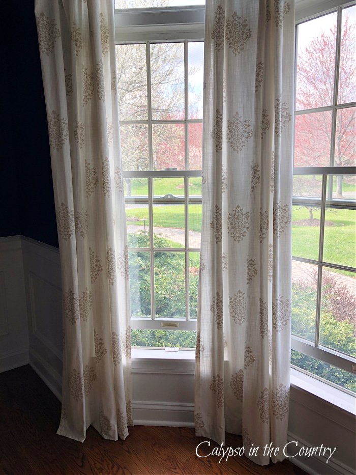 Tan and white block print curtain panels in bay window - block print home decor