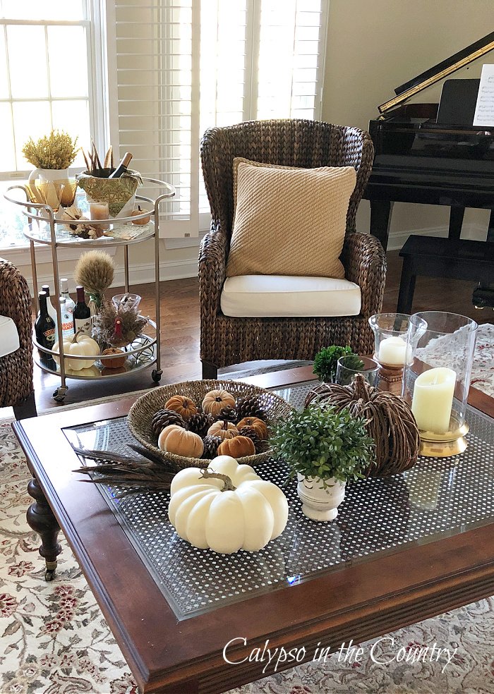 White pumpkin and neutral accessories in living room - fall coffee table decor ideas