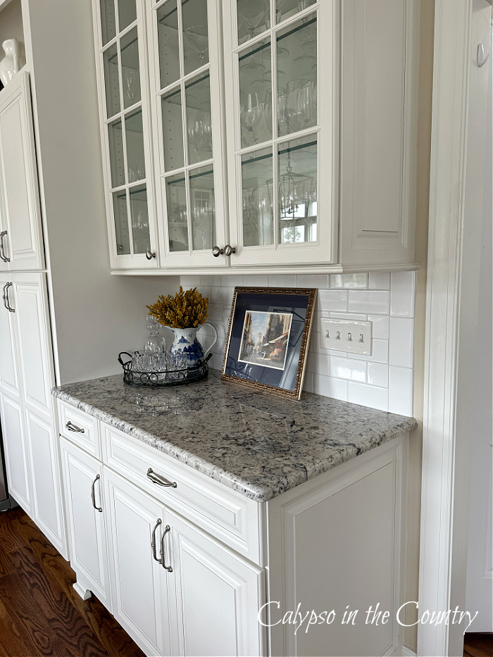 White kitchen cabinets and corner fall vignette