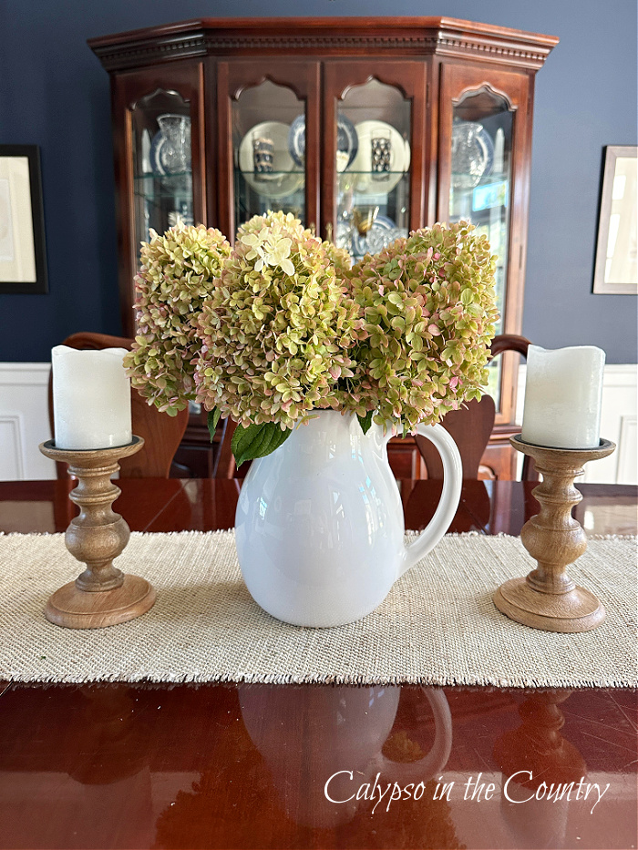 Hydrangeas in white pitcher on dining room table - fall aesthetic ideas