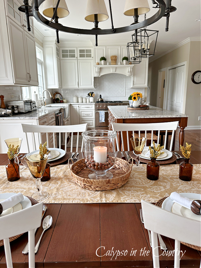 Kitchen dining table decorated for fall with neutrals 