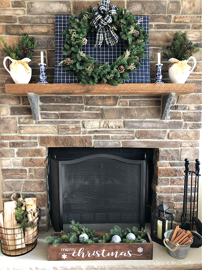 Stone fireplace Christmas decorations on rustic wood mantel