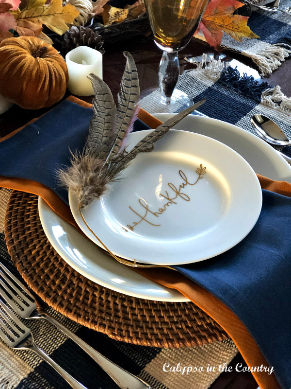 Blue, white and orange place setting with feathers and thankful plate - Thanksgiving feather decoration ideas