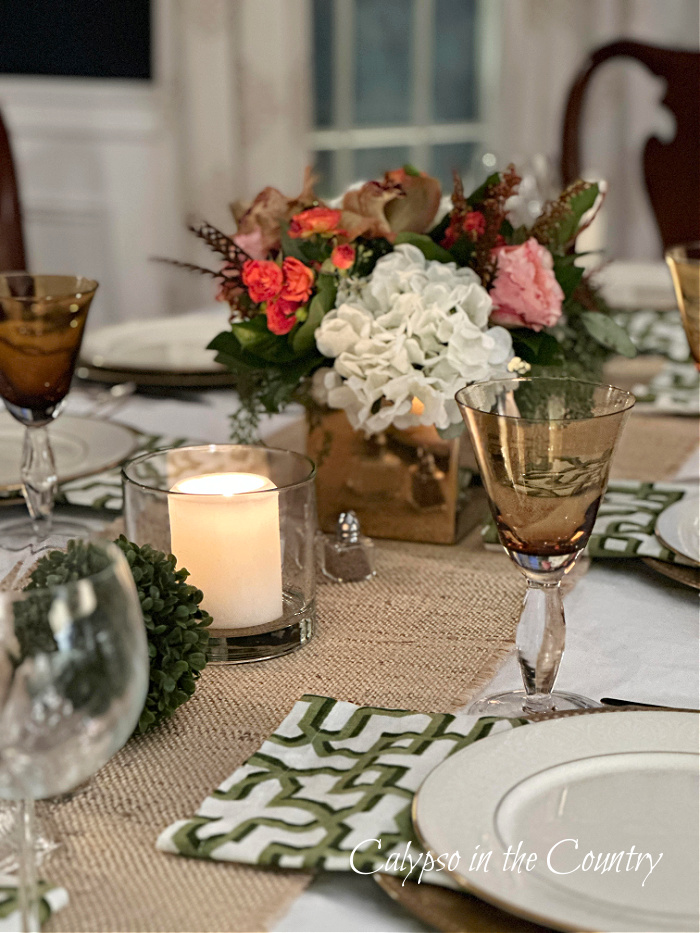 Neutral and green table setting with floral centerpiece
