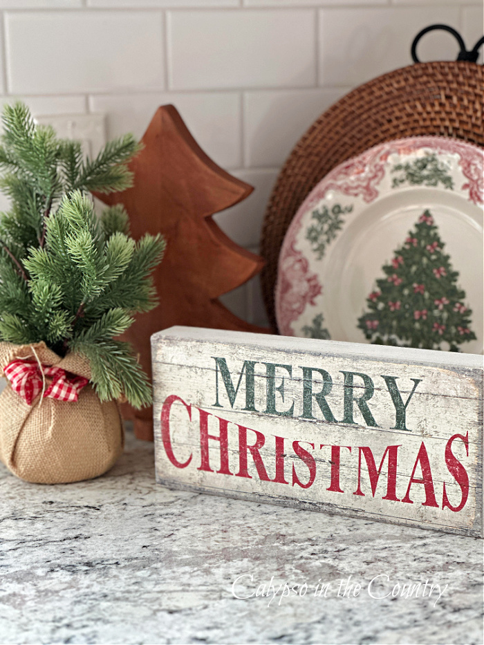 Merry Christmas sign and decorations on countertop