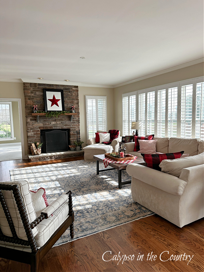 Family room with plantation shutters and stone fireplace - cozy Christmas home tour 
