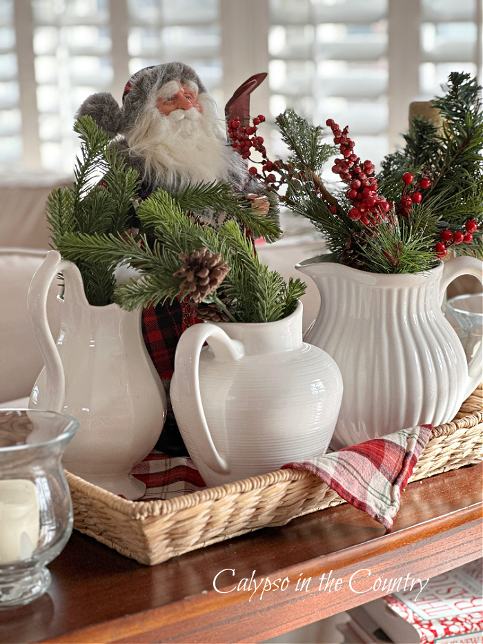 Santa vignette with white pitchers and greenery - cozy Christmas home tour