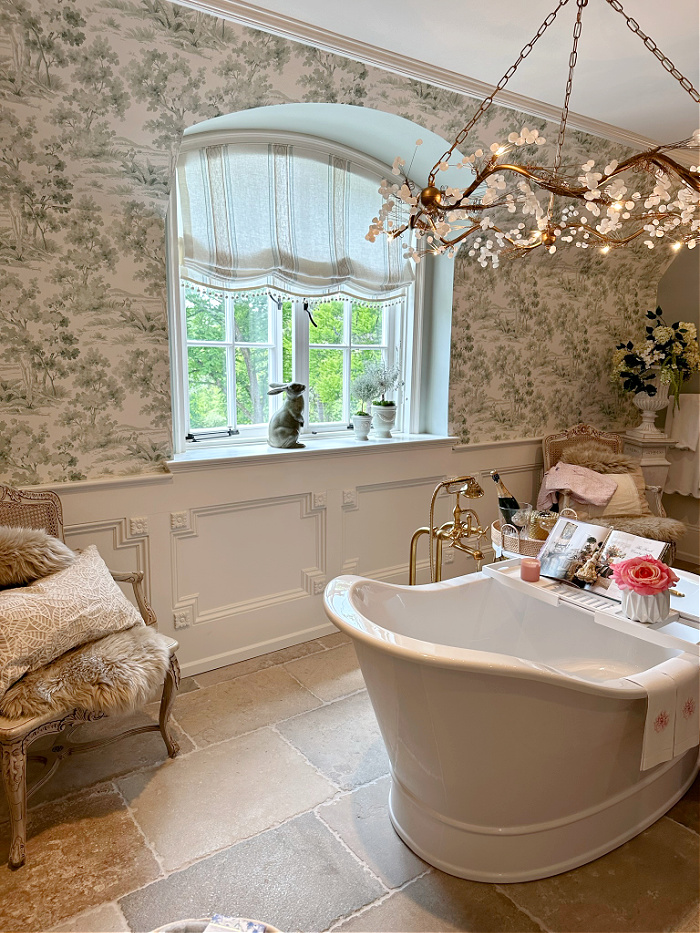Free standing white bathtub in front of arched window - traditional bathroom ideas 