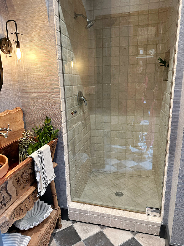 Tumbled marble tiled shower stall in bathroom