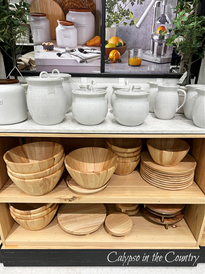 White canisters and wooden bowls on store shelves - January decorating inspiration