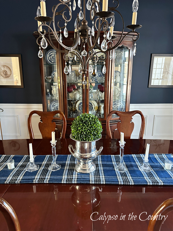 blue plaid table runner with silver wine bucket on center of cherry dining table - cozy winter decorating ideas