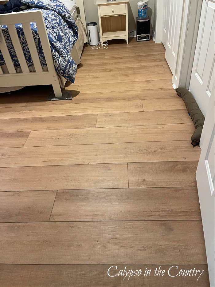 light brown plank floor in bedroom 