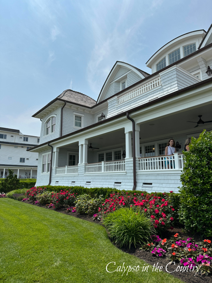 large beach house exterior with pink flowers and manicured lawn - June recap