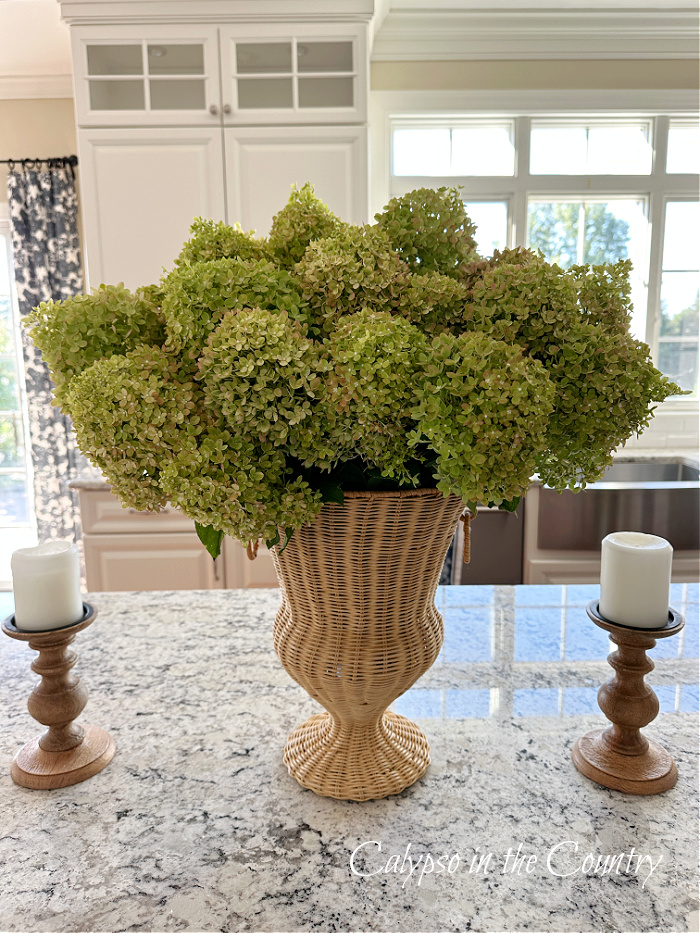 Green hydrangeas in woven vase on kitchen island - decorating with hydrangeas from summer to fall