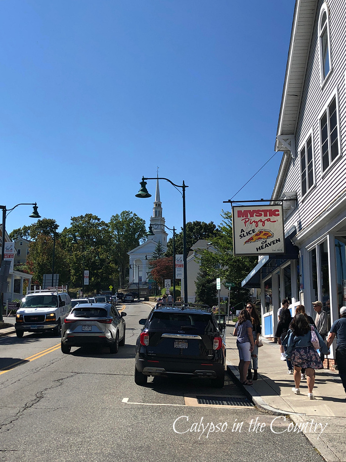 Street with cars and Mystic Pizza sign - coastal Connecticut places
